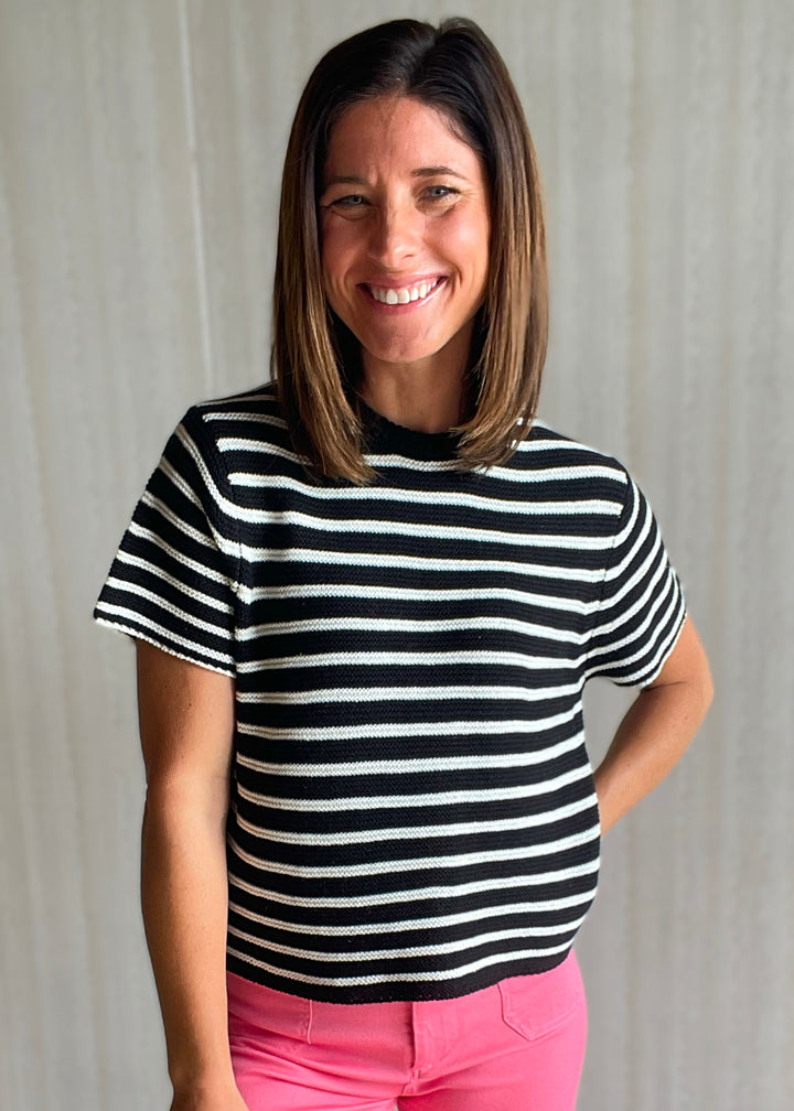 Women’s black and white striped short sleeve sweater with pink pants