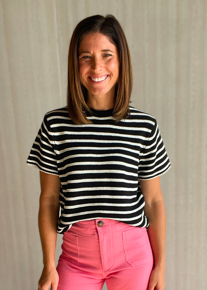 Women’s black and white striped short sleeve sweater with pink pants