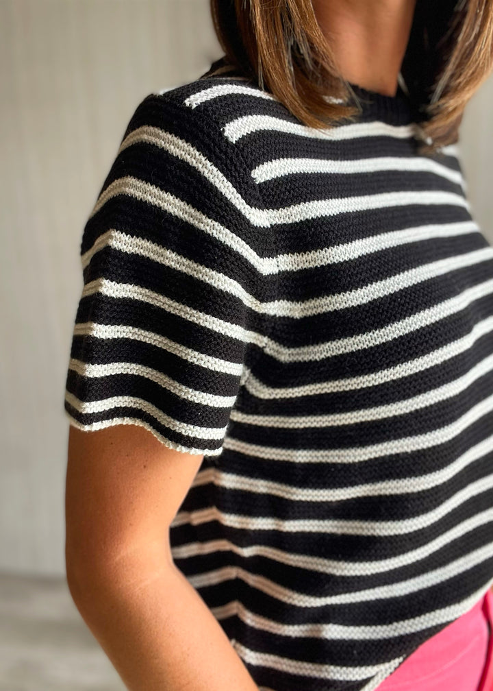 Women’s black and white striped short sleeve sweater with pink pants