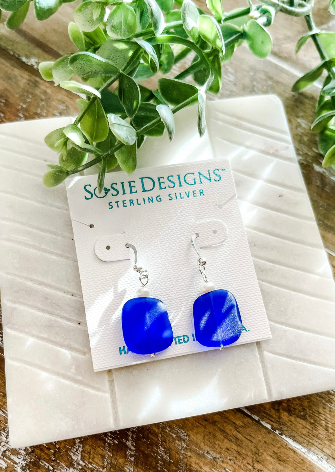 Cobalt Blue Eco Sea Pearl Earrings, made with sterling silver in the U.S.A. Small white pearl on top of the blue cobalt stone.