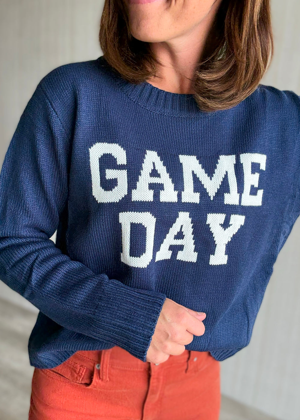 Women's Classic Navy Game Day Sweater with orange jeans