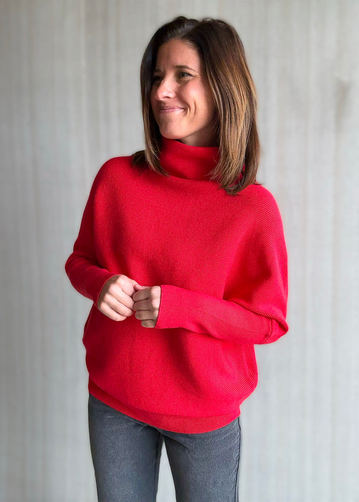 Woman wearing a red sweater against a plain background - Red Dolman Sleeve Mock Neck Sweater