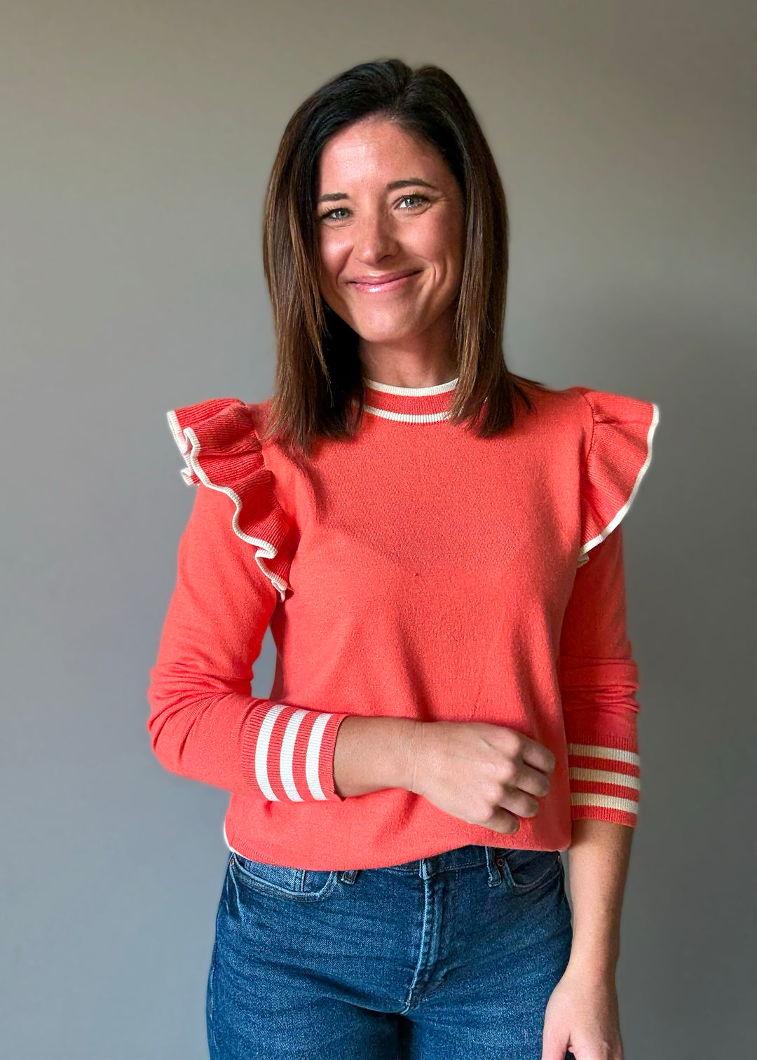 Women's Coral Orange Ruffle Shoulder Sweater with off-white cream stripes | Orange Sweaters for Game Day Outfits