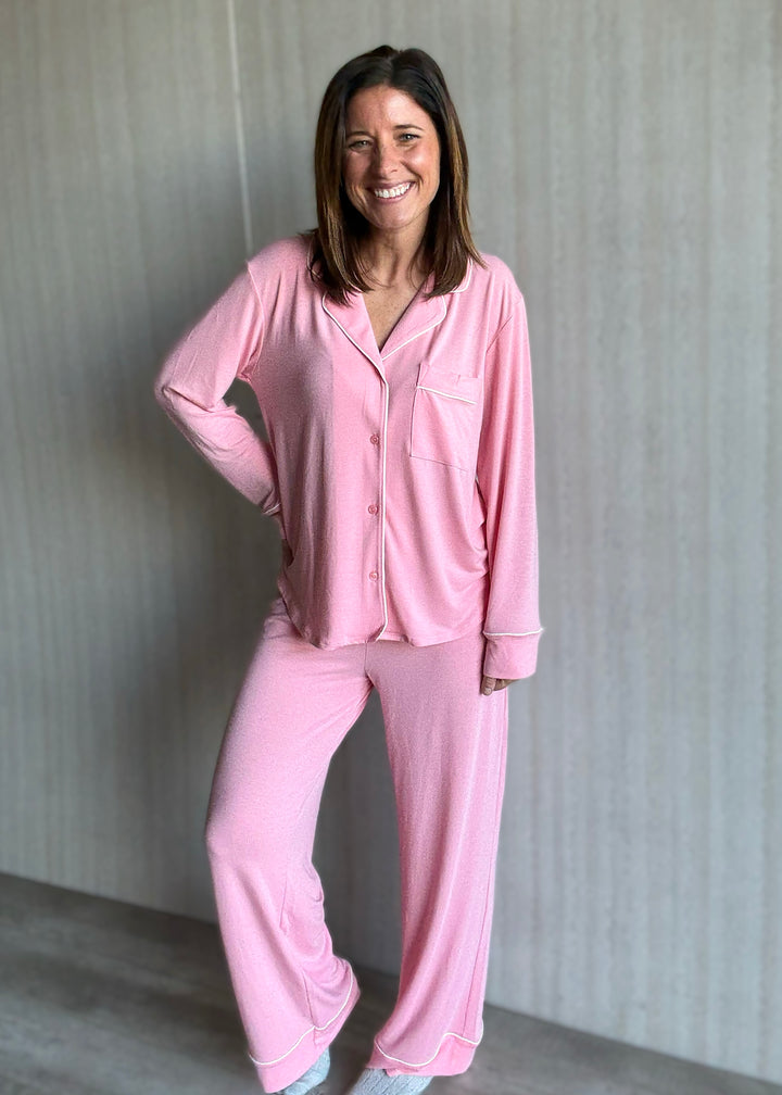Woman wearing a pink pajama set against a neutral background