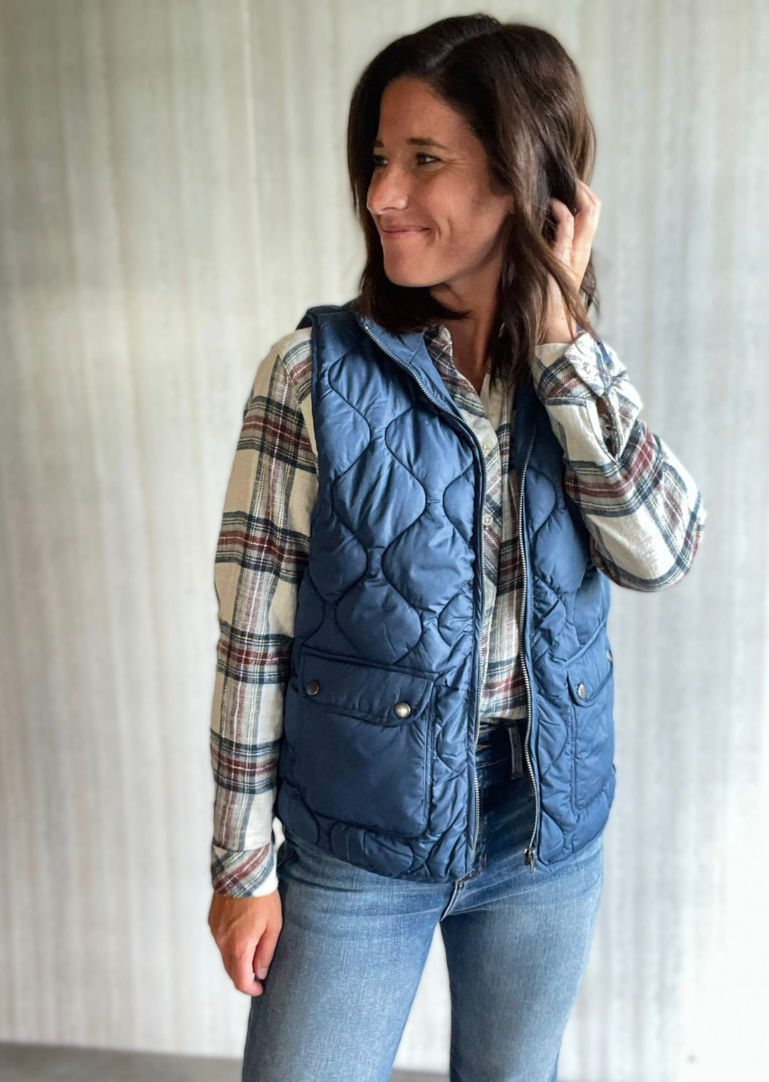 Thread & Supply Blue Vest paired with white, maroon, and blue flannel and jeans. Central Illinoi Women's Clothing Boutique.