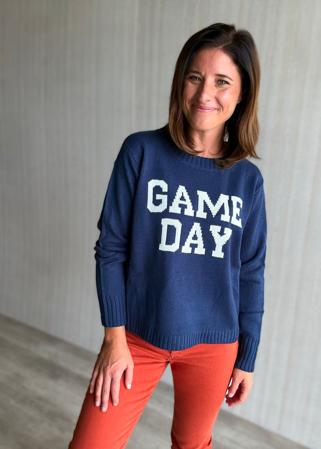 Women's Classic Navy Game Day Sweater with orange jeans
