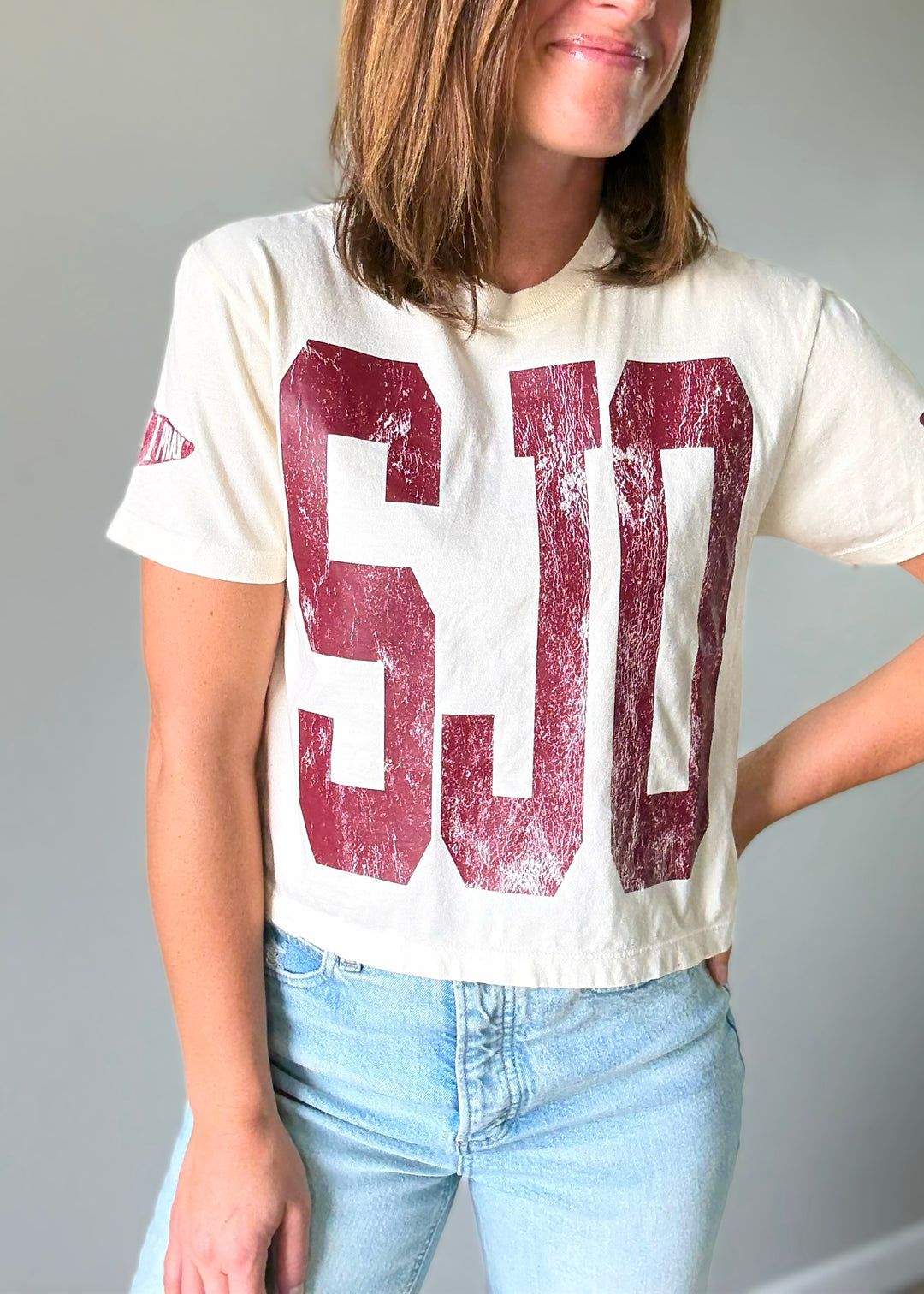 Cute Women's Cream SJO Spartans Cropped T-Shirt with maroon lettering