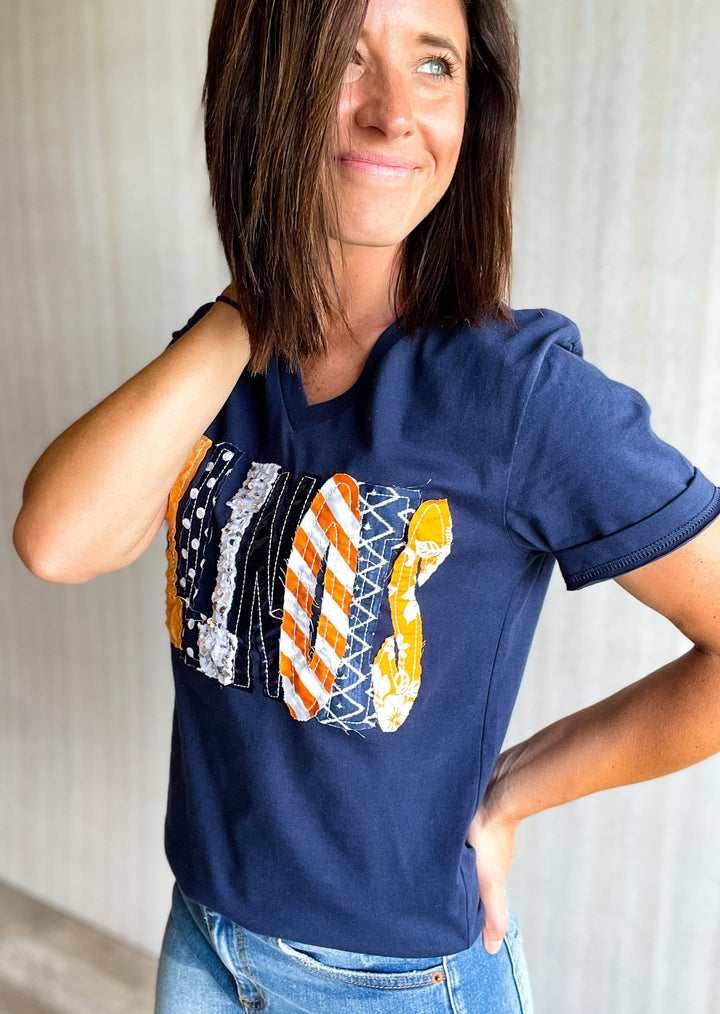 Navy Illinois V-neck t-shirt with sequin, sparkly, orange, white, and blue Illinois letters.