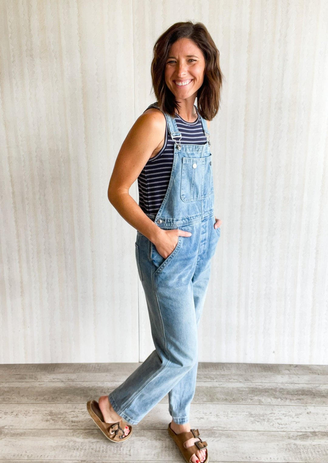 Women's Denim Overalls with navy and white striped tank top.