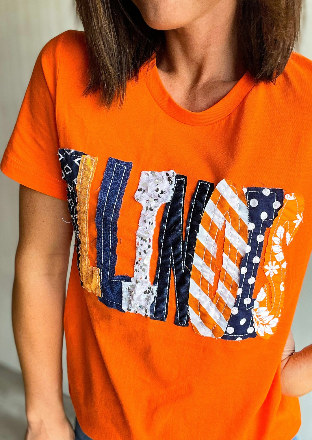 Orange Illinois T-shirt with navy, orange, and white sparkly letters.