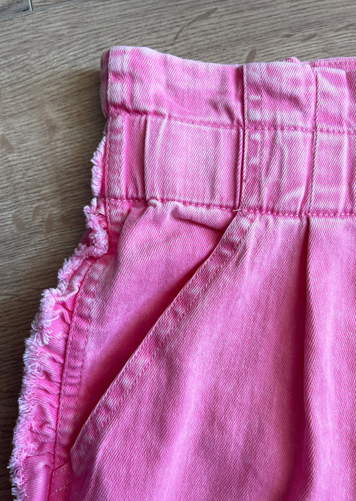 Pink Pleated Shorts at Embolden. Close up details.
