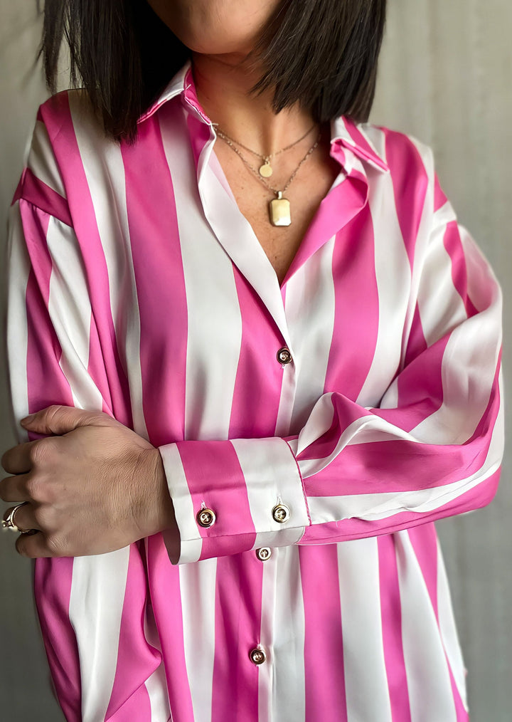 Pink and White striped Button down top with gold buttons paired with black distressed denim jeans