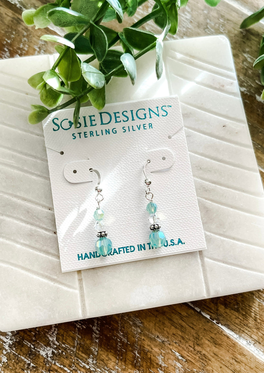 Three tiered crystal earrings with light-green and clear crystals; include silver accents.
