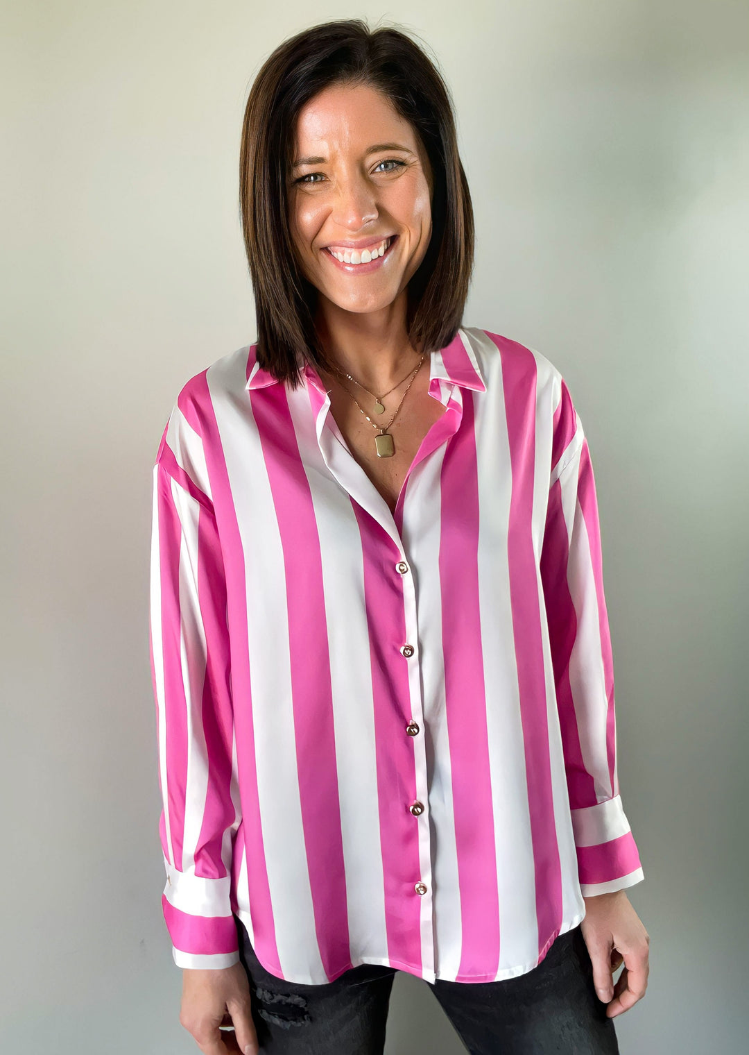 Pink and White striped Button down top with gold buttons paired with black distressed denim jeans