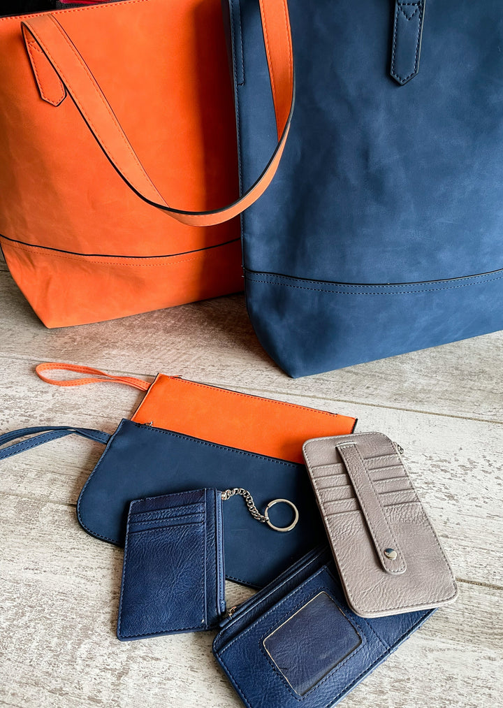 Orange and Navy Suede Bags with matching wristlets and credit card holders.