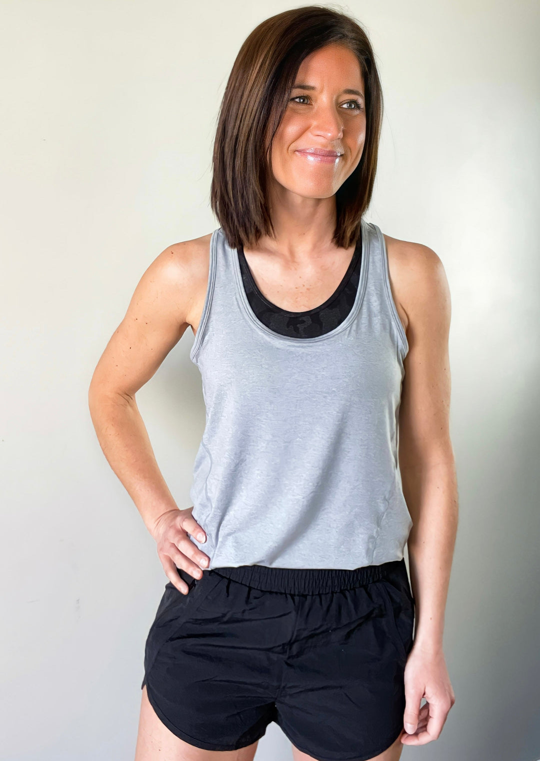Light Gray Racerback Workout Tank with black banded athleisure shorts