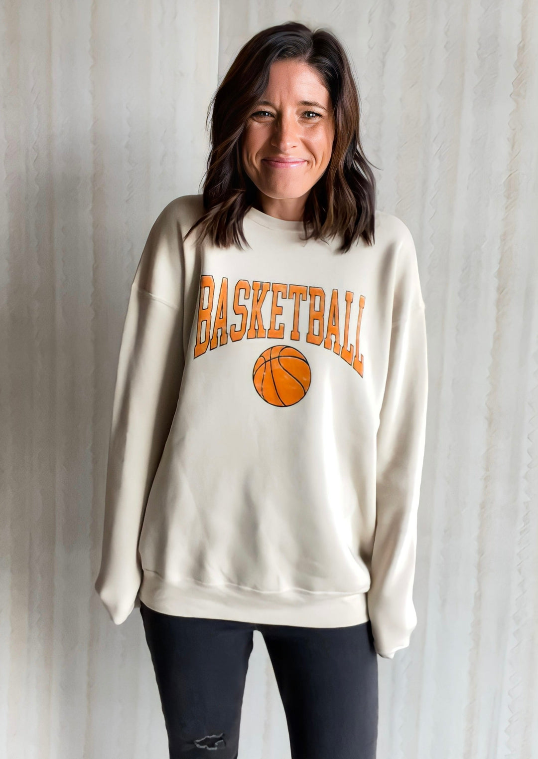 Women's Neutral Basketball Sweatshirt. Cream Sweatshirt with Basketball text and grahic in light orange. Sweatshirt from Champaign-Urbana, Illinois Embolden boutique.
