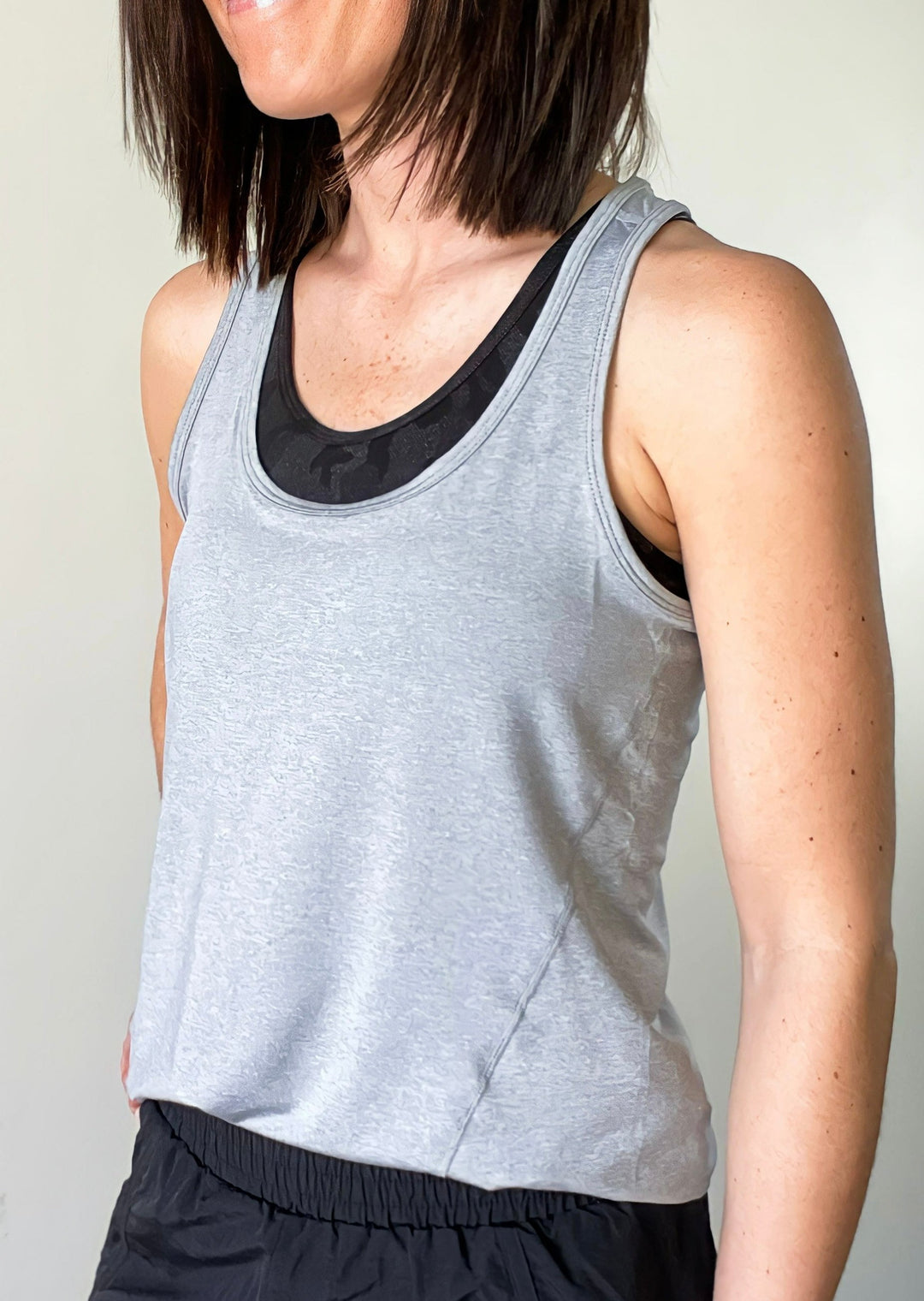 Light Gray Racerback Workout Tank with black banded athleisure shorts