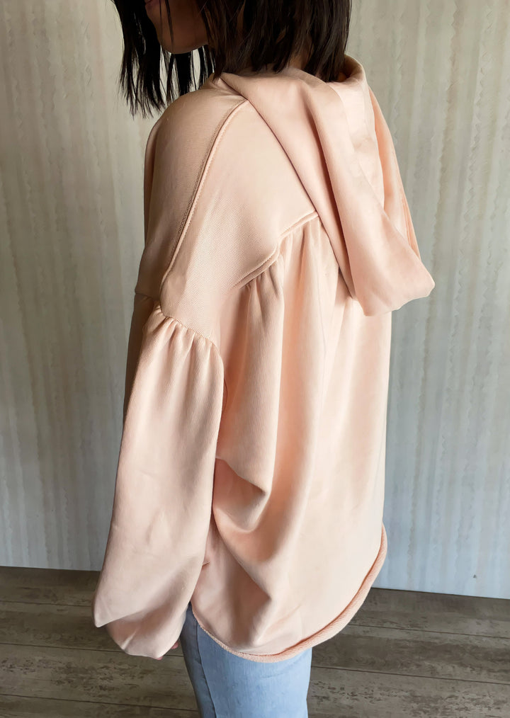 Light Pink Cotton French Terry Oversized Hoodie with balloon sleeves, v-neck, distressed hems, and a cropped waist.